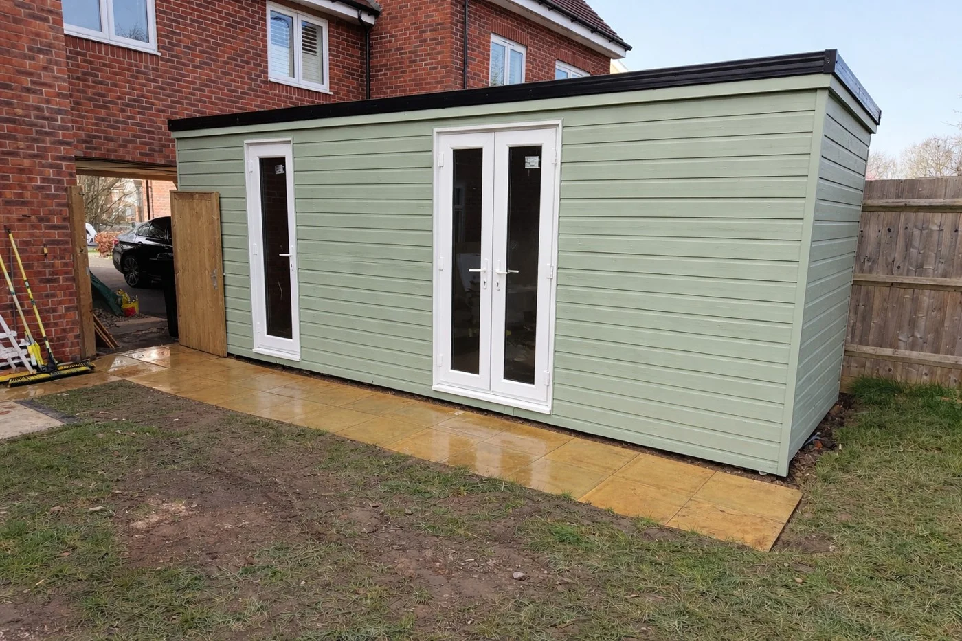 Completed garden-room exterior with separate laundry and storage entrances.
